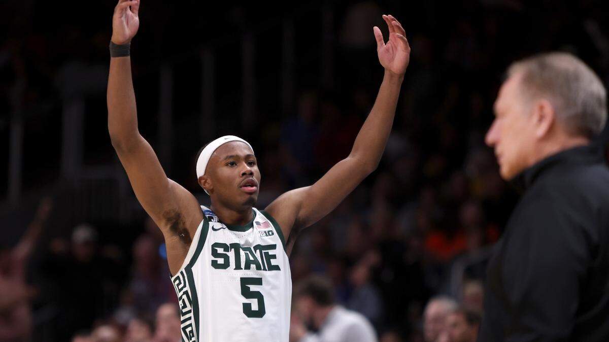 Michigan State Spartans guard Tre Holloman (5) reacts after a play in the second half of a South Regional semifinal of the 2025 NCAA tournament against the Mississippi Rebels at State Farm Arena.