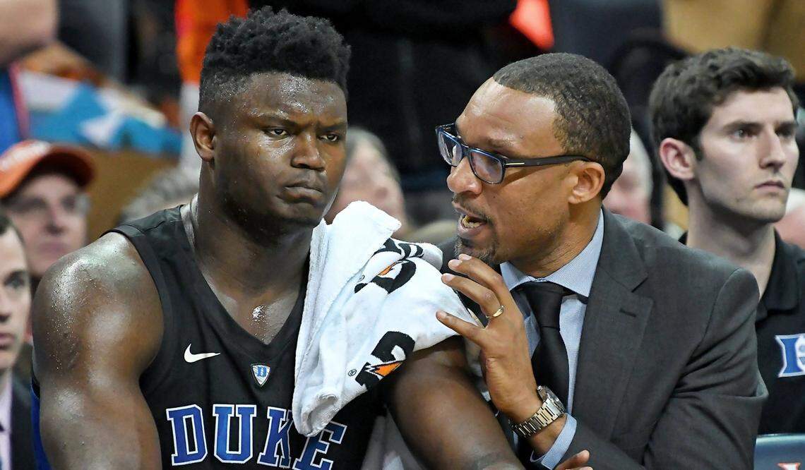 Duke forward Zion Williamson (1) listens as assistant coach Chris Carrawell speaks with him during a game against Virginia at John Paul Jones Arena in Charlottesville, Va., Saturday, Feb. 9, 2019.