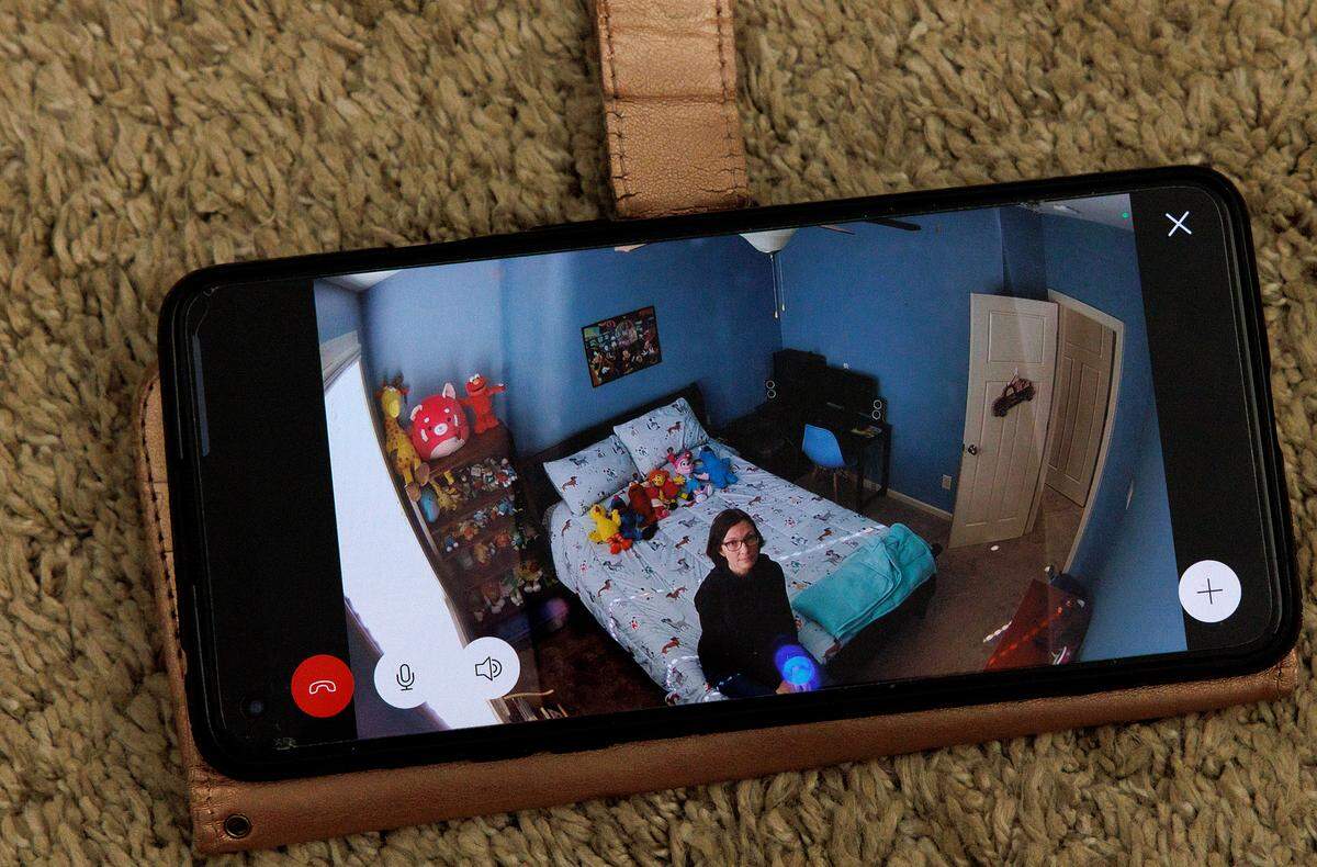 Tiffanie Brinson is photographed via a video monitor while sitting in her son’s bedroom at home in Garner, N.C. on Monday, Jan. 22, 2024. The room is designed as a safe space to care for her son, who lives with autism and bipolar disorder, during his periodic psychiatric crises.
