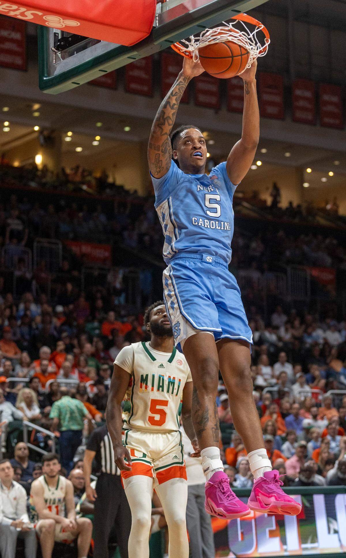North Carolina’s Armando Bacot (5) gets a dunk over Miami’s Wooga Poplar (5) in the first half on Saturday, February 10, 2024 at the Watsco Center in Coral Gables, Florida.