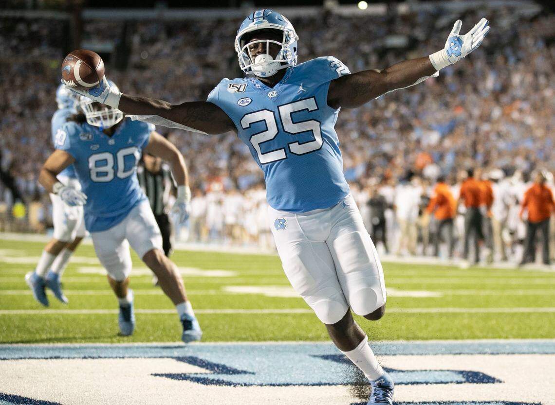 Javonte Williams (25) scores on a two-yard carry for a touchdown to give the Tar Heels a 17-3 lead over Miami in the first quarter on Saturday, September 7, 2019 at Kenan Stadium in Chapel Hill, N.C.