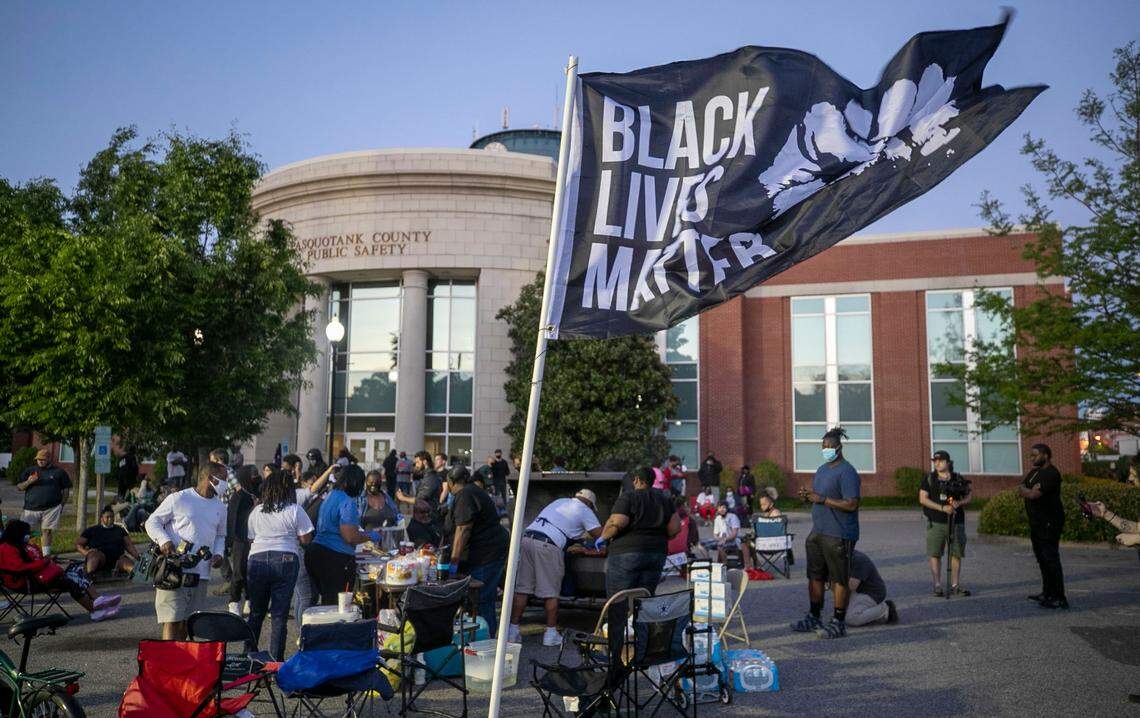 Demonstrators gather in the parking lot of the Pasquotank County Sheriff’s offices for a cookout on Friday, April 30, 2021 in Elizabeth City, N.C. Local leaders opted for a cookout instead of march early Friday evening. This is the 10th day demonstrators have gathered in Elizabeth City following the death of Andrew Brown Jr. at the hands of Pasquotank County deputies.