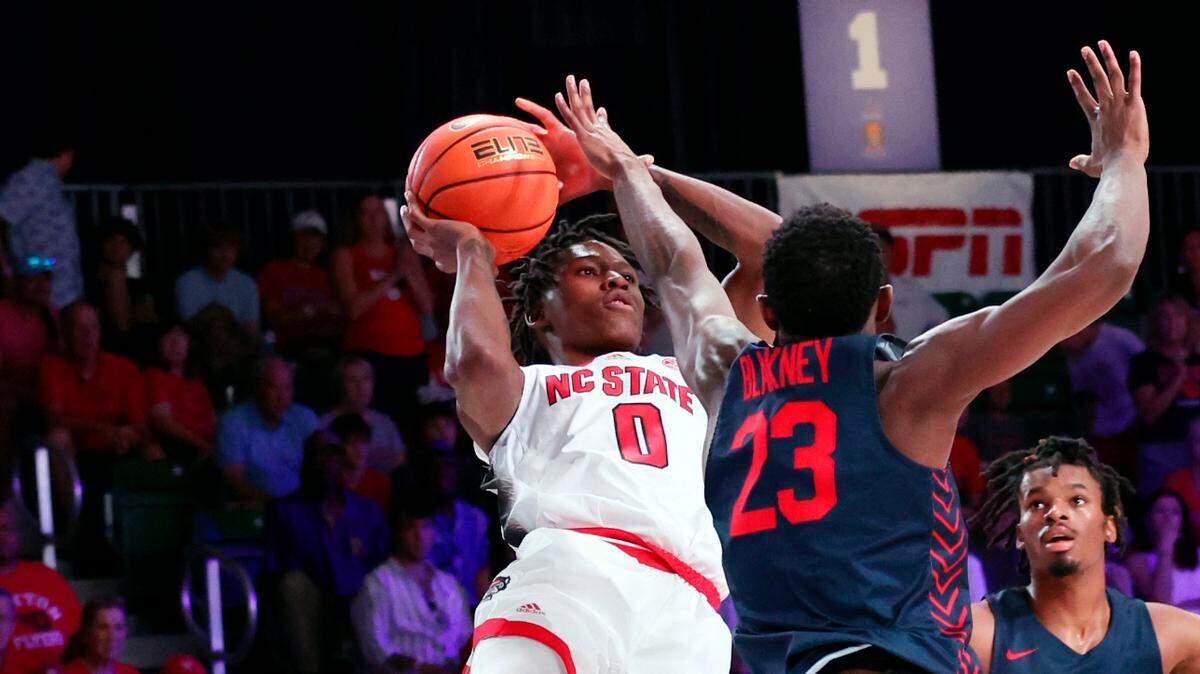 In a photo provided by Bahamas Visual Services, North Carolina State’s Terquavion Smith (0) shoots over Dayton’s R.J. Blakney (23) during an NCAA college basketball game in the Battle 4 Atlantis at Paradise Island, Bahamas, Thursday, Nov. 24, 2022. (Tim Aylen/Bahamas Visual Services via AP)