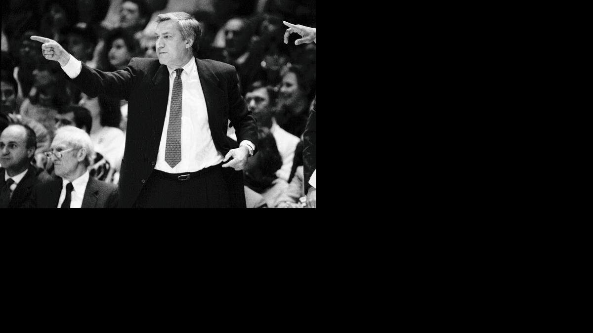 UNC coach Dean Smith points to one of his players who  made an assist during a 1988 ACC Tournament game in Greensboro.
