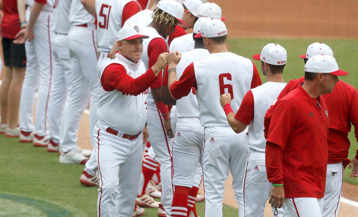 N.C. State head coach Elliott Avent greets players, including Vojtech Mensik (6) during introductions before during N.C. State’s game against Duke in the ACC Baseball Championship game at Truist Field in Charlotte, N.C., Sunday, May 30, 2021.