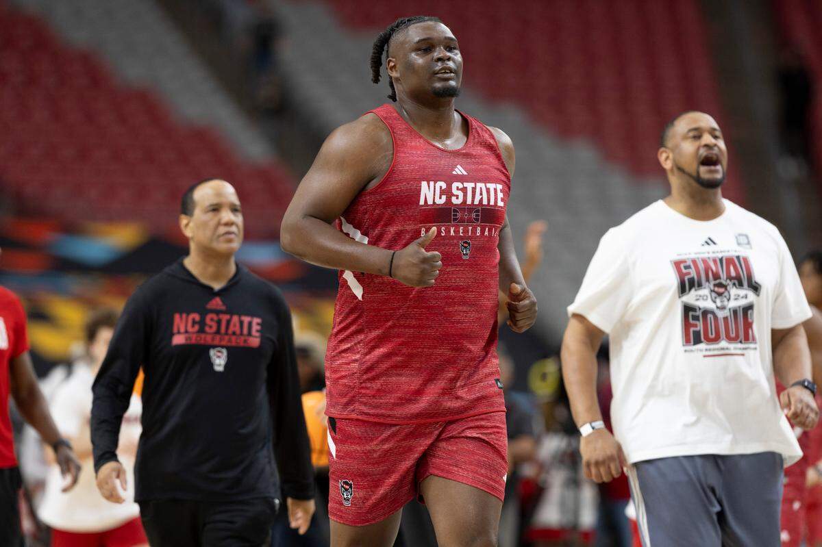 North Carolina State coach Kevin Keatts, D.J. Burns Jr. (30) and assistant coach Levi Watkins take to the court for their practice on Friday, April 5, 2024, as they prepare for their NCAA National Semi-Final game against Purdue at State Farm Stadium in Glendale, AZ.