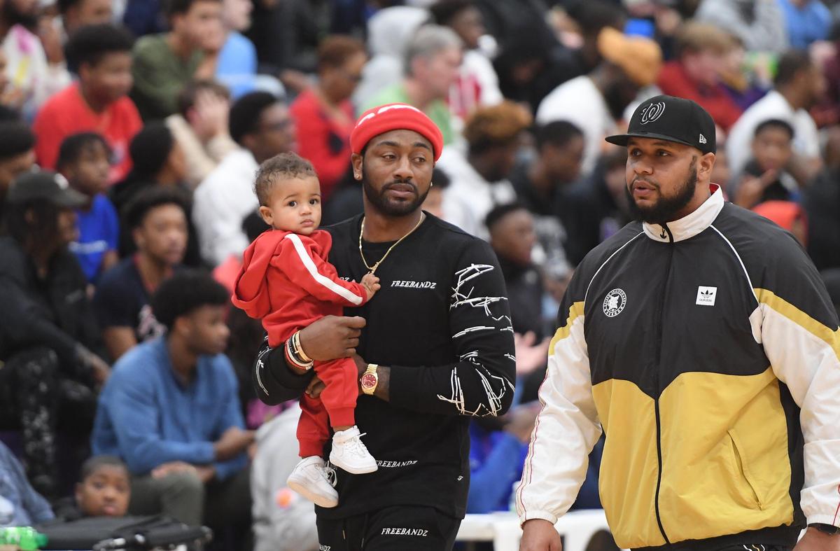 John Wall, center, walks on the court before the start of the game. The Durham Academy Cavaliers played the Montverde Academy Eagles in a boys basketball game that was part of the John Wall Holiday Invitational on December 27, 2019.