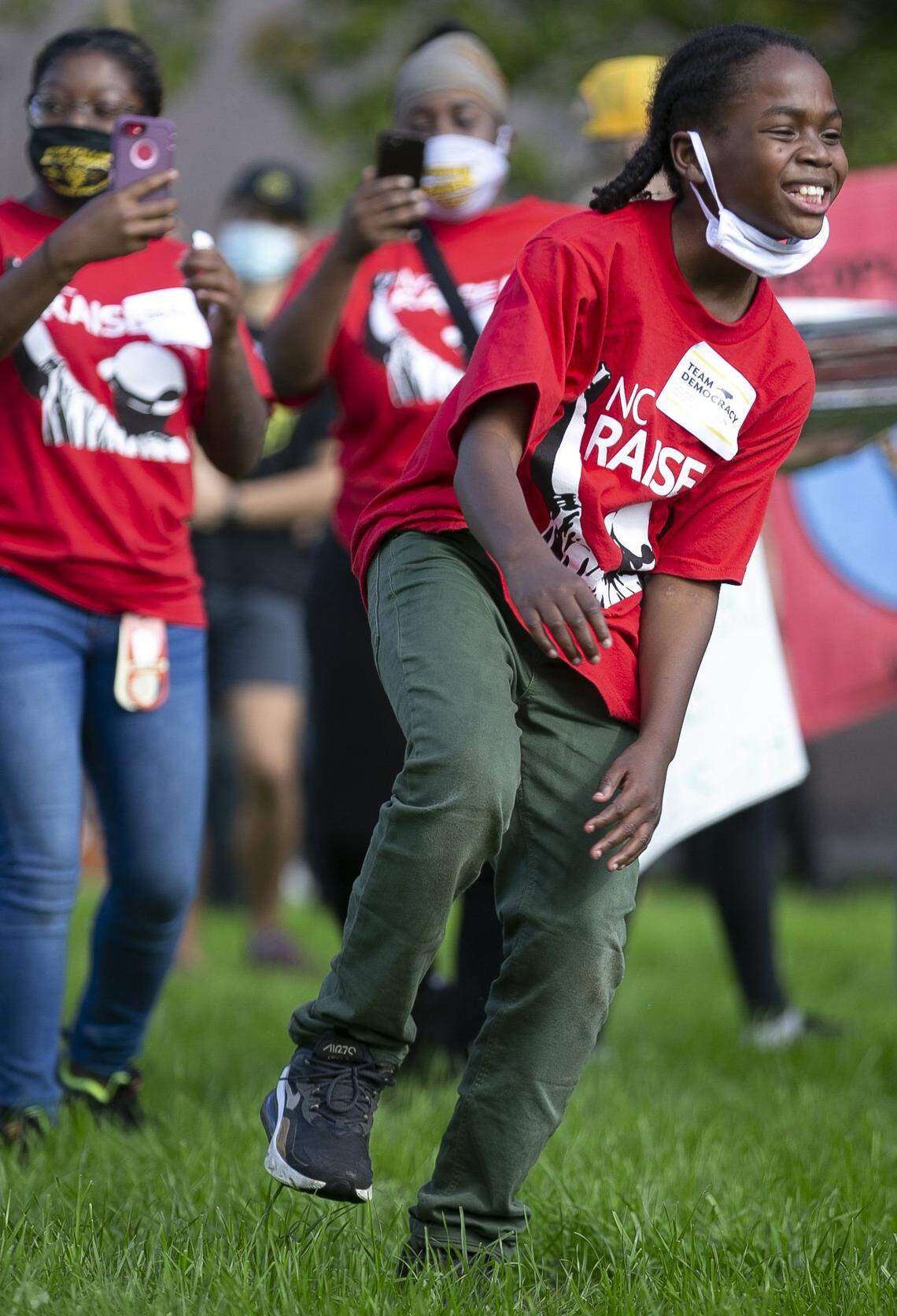 Ten-year-old Larry Collins dances during a ‘Team Democracy Protect Our Vote Rally’ on the Halifax Mall behind the Legislature on Saturday, November 7, 2020 in Raleigh, N.C.