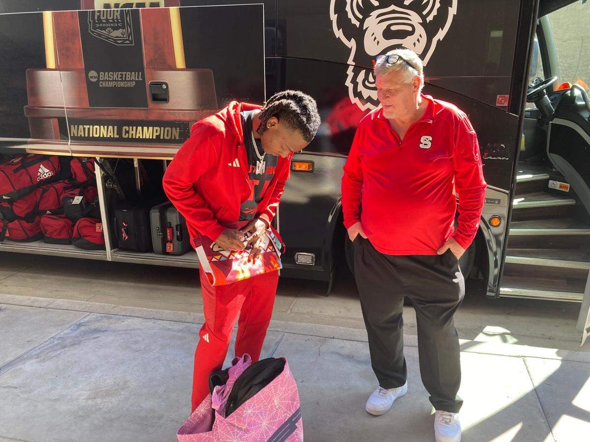 NC State guard D.J. Horne signs a few autographs for a Wolfpack fan Sunday, April 7, 2024 before the team departed Phoenix for its return to Raleigh after the NCAA Final Four.