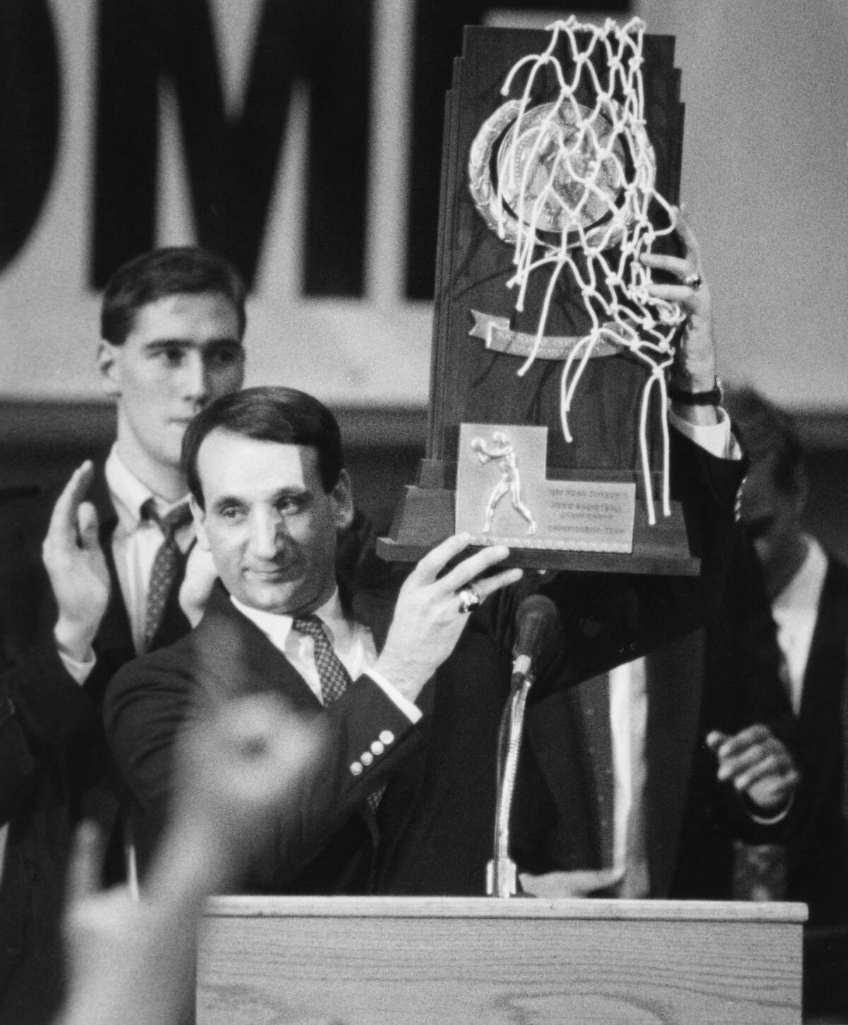 Duke coach Mike Krzyzewski holds up the national Championship trophy to the crowd during a celebration in Cameron Indoor Stadium April 2, 1991.