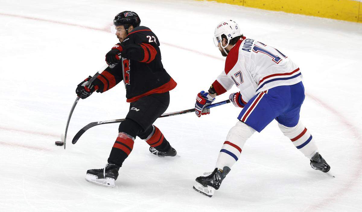 Carolina's Logan Stankoven (22) shoots as Montréal's Josh Anderson (17) defends during the first period of the Hurricanes’ game against the Canadiens in game five of the Eastern Conference Finals at the Lenovo Center Friday, May 29, 2026.