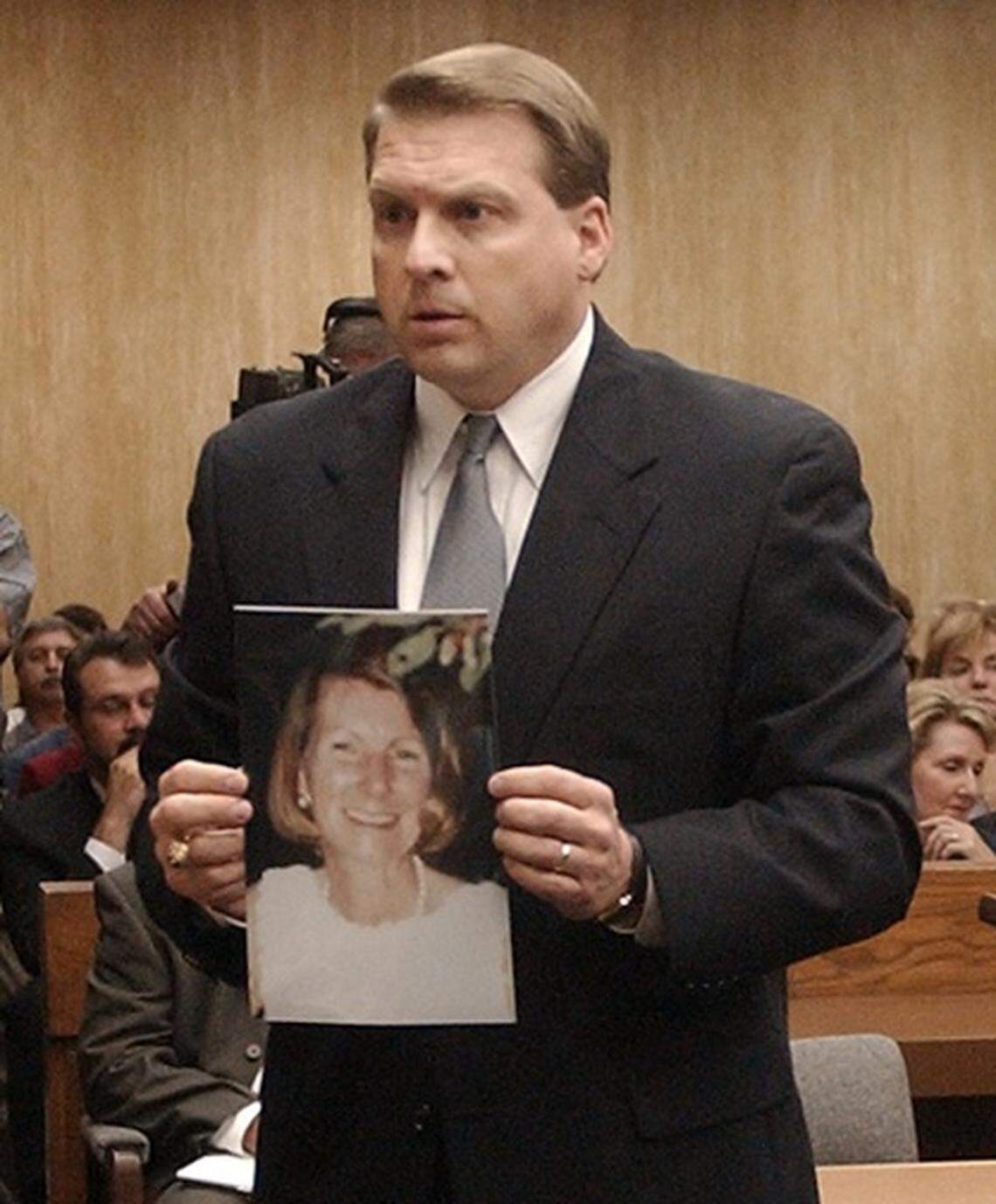 Durham District attorney Jim Hardin holds a photo of Kathleen Peterson during opening statement’s Tuesday in the murder trial of Michael Peterson.