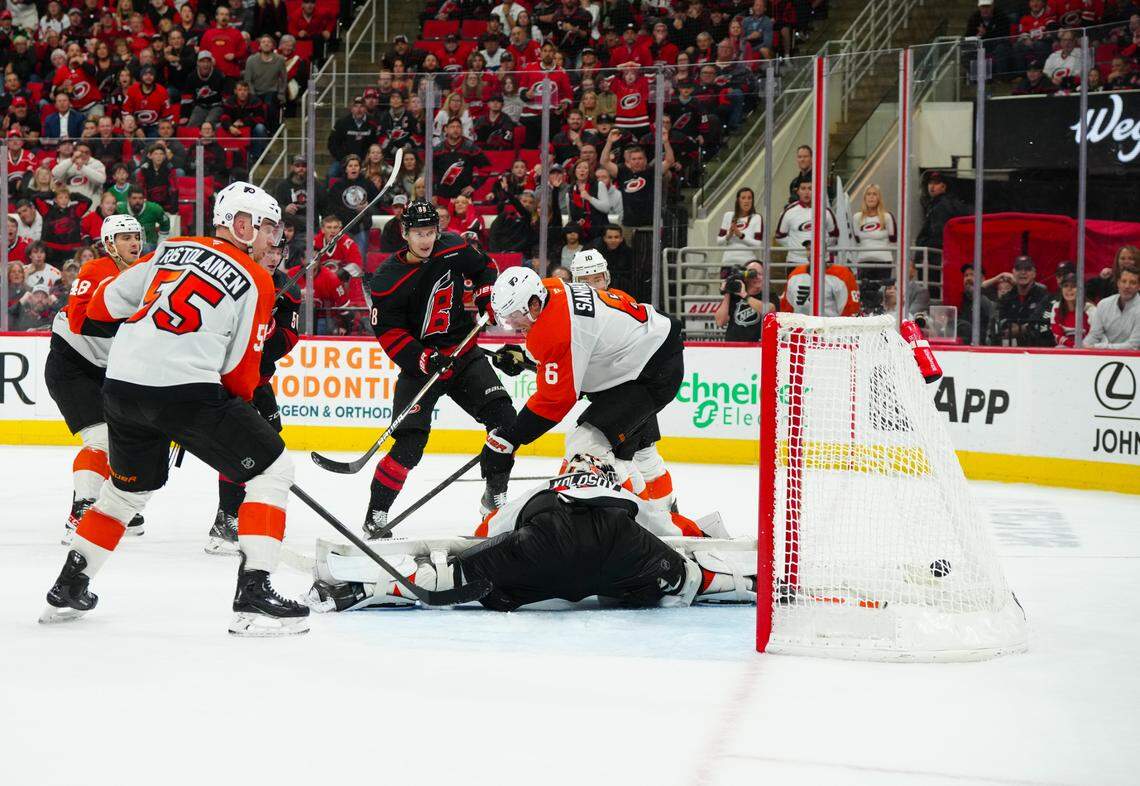 Nov 5, 2024; Raleigh, North Carolina, USA; Carolina Hurricanes center Martin Necas (88) scores the game winner against Philadelphia Flyers goaltender Aleksei Kolosov (35) defenseman Travis Sanheim (6) and defenseman Rasmus Ristolainen (55) during the third period at Lenovo Center. Mandatory Credit: James Guillory-Imagn Images