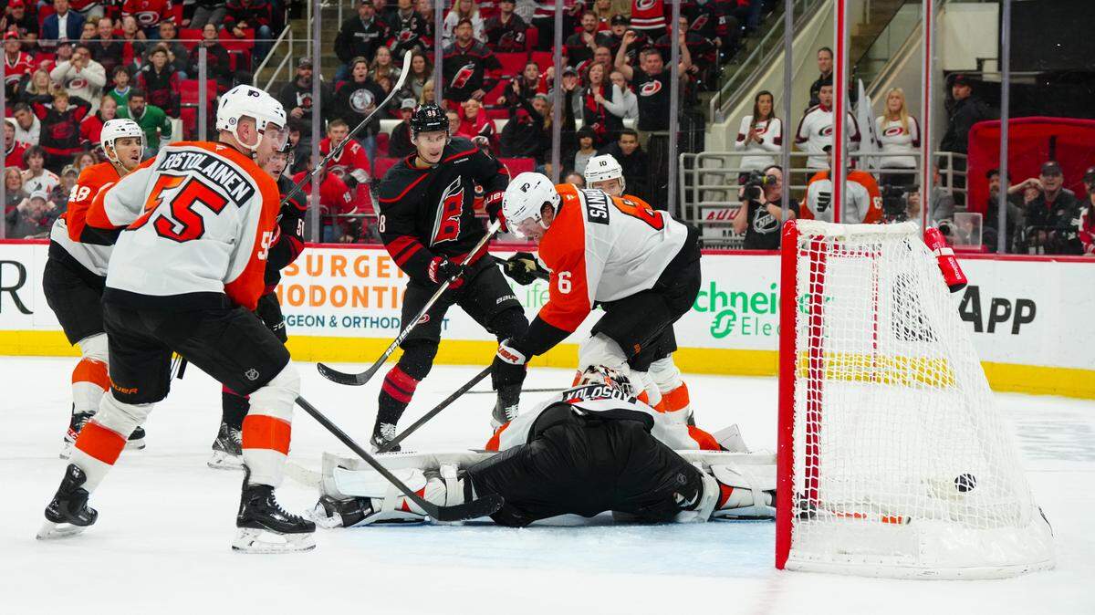Carolina Hurricanes center Martin Necas (88) scores the game winner against Philadelphia Flyers goaltender Aleksei Kolosov (35) defenseman Travis Sanheim (6) and defenseman Rasmus Ristolainen (55) during the third period at Lenovo Center.