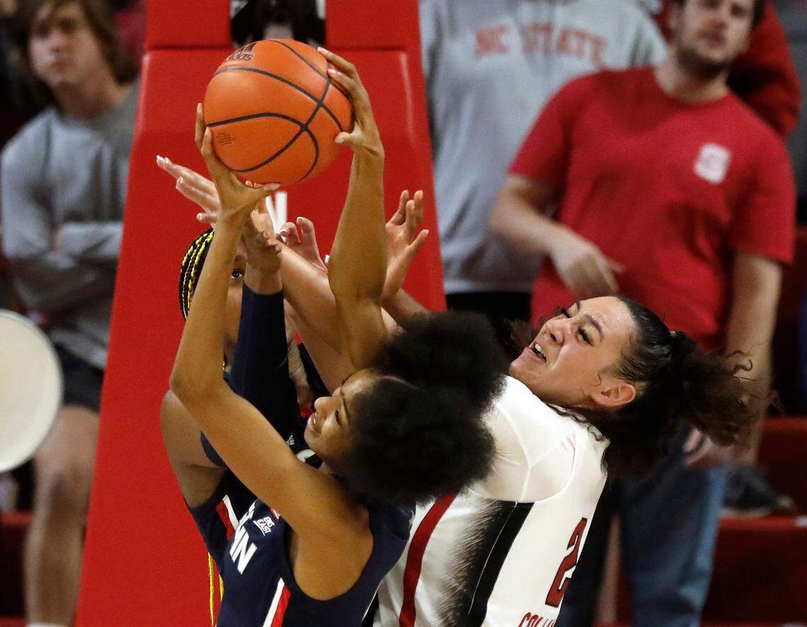 N.C. States Mimi Collins battles UConn’s Aaliyah Edwards and Qadence Samuels for a rebound during the second half of the Wolfpack’s 92-81 win on Sunday, Nov. 12, 2023, at Reynolds Coliseum in Raleigh, N.C.