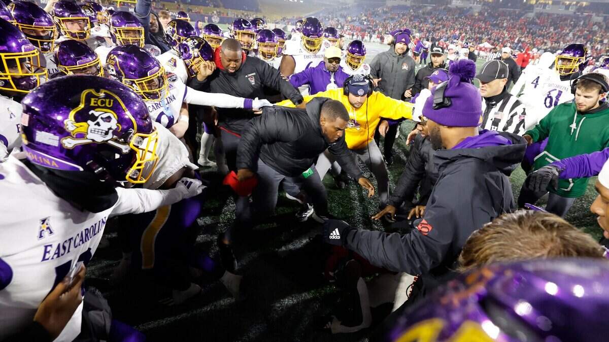 N.C. State safety Rente Hinton (14) is surrounded by East Carolina players during a scuffle near the end of ECU's 26-21 victory over N.C. State in the Military Bowl at Navy-Marine Corps Memorial Stadium in Annapolis, Md., Saturday, Dec. 28, 2024.