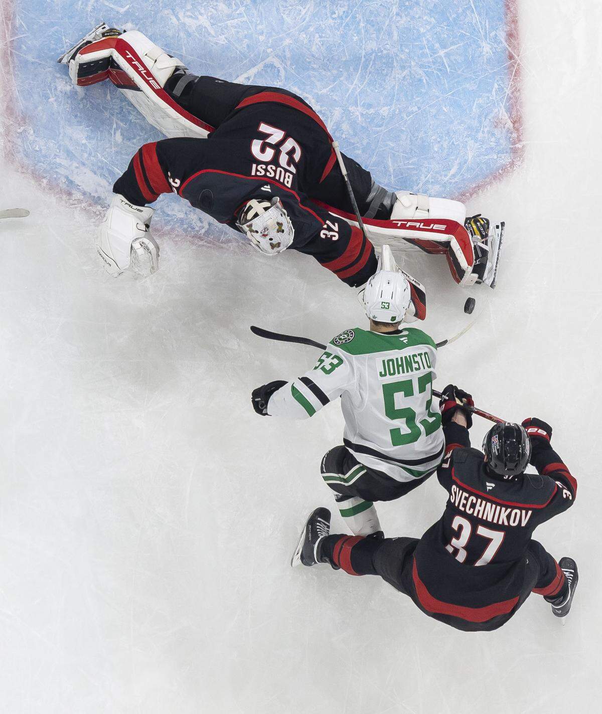 Carolina Hurricanes goalie Brandon Bussi (32) stops a scoring attempt by Dallas center Wyatt Johnston (53) in the first period on Tuesday, January 6, 2026 at Lenovo Center in Raleigh, N.C. Bussi made 29 saves in the Hurricanes’ 6-3 victory.