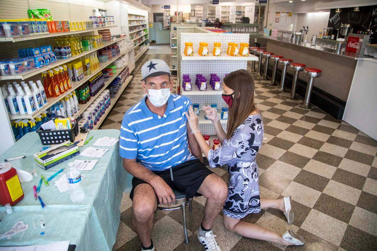Dr. Stephanie Bellows prepares to administer a COVID-19 vaccine to William Gresham at Guiton’s Drug Store in Whiteville Thursday, July 29, 2021. Columbus County has the state’s highest rate for COVID-19 and one of the lowest for vaccinations. Dr. Bellows vaccinated 38 people on Thursday.