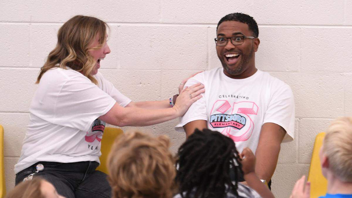 Shane Henderson, a fourth-grade teacher at Pittsboro Elementary School, reacts to the news Wednesday that he’s received a Milken Educator Award.