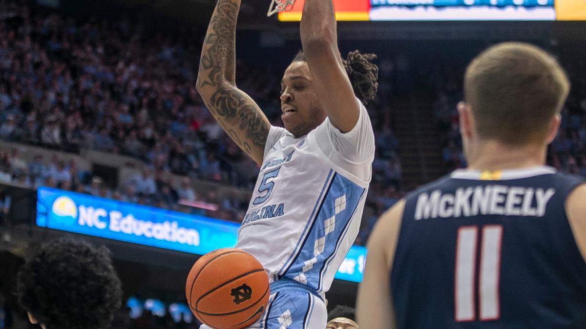 North Carolina’s Armando Bacot (5) dunks over Virginia’s Kihei Clark (0), Jayden Gardner (1), and Isaac McKneely (11) in the first half on Saturday, February 25, 2023 at the Smith Center in Chapel Hill, N.C.