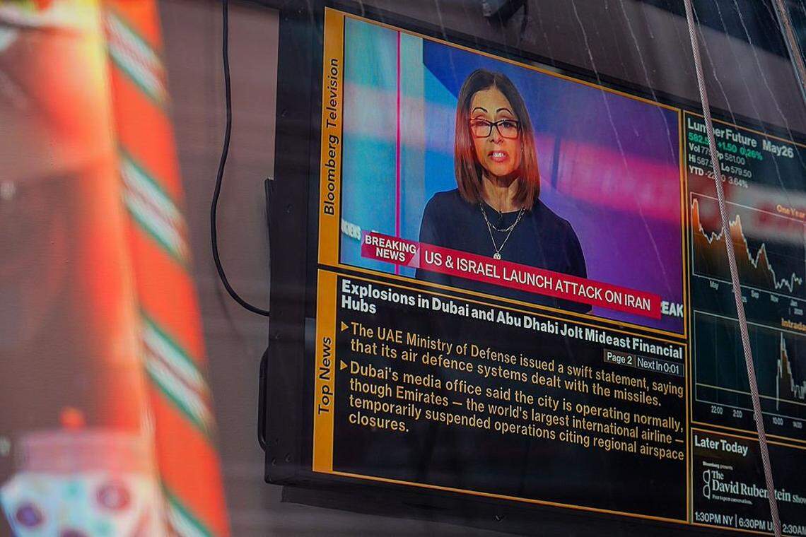 NEW YORK, NEW YORK - FEBRUARY 28: A television at the NASDAQ building in Times Square displays a news headline reading "US & Israel Launch Attack On Iran" on February 28, 2026 in New York City. U.S. President Donald Trump announced that the United States and Israel had launched an attack on Iran Saturday morning. (Photo by Ryan Murphy/Getty Images)
