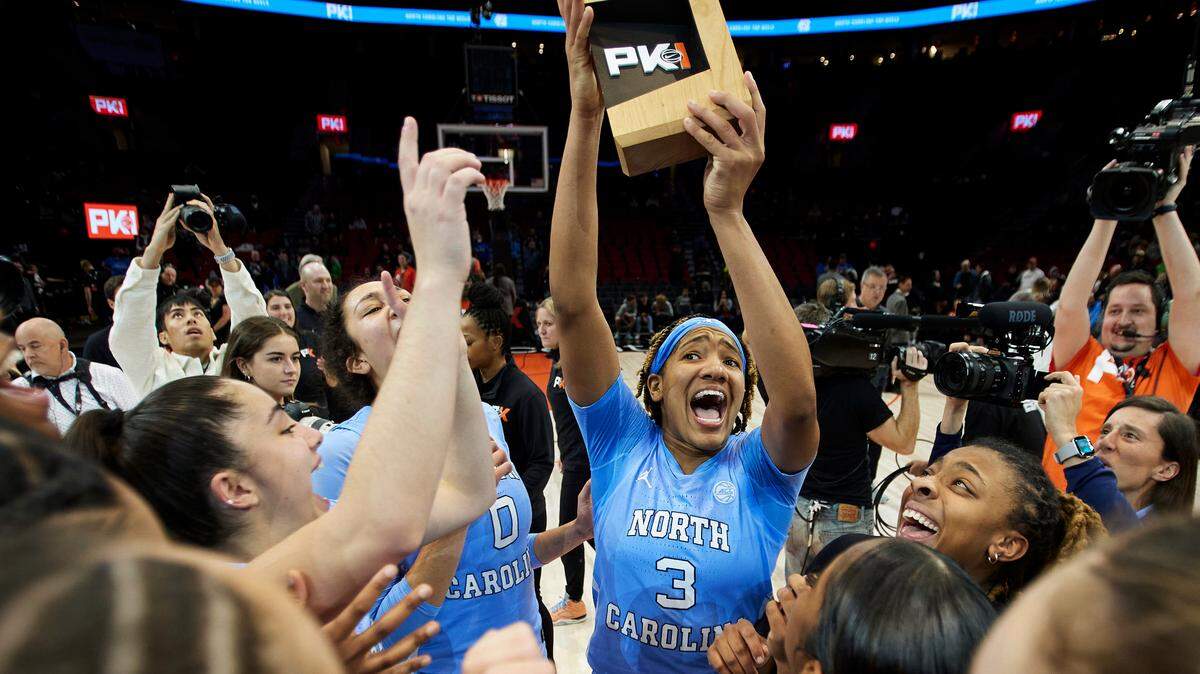 North Carolina guard Kennedy Todd-Williams (3) holds up the championship trophy after the team’s 73-64 win over Iowa State in an NCAA college basketball game in the Phil Knight Invitational in Portland, Ore., Sunday, Nov. 27, 2022.