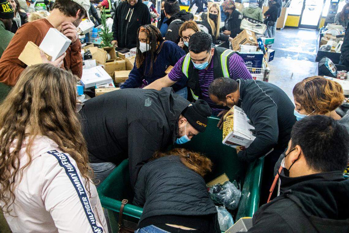 Shoppers scour merchandise bins at Treasure Hunt Liquidators Friday, Jan. 14, 2022 in Raleigh. The 4,000-square-foot space features bargain bins that refill each Friday offering products from retailers like Target, Best Buy and Amazon returns.