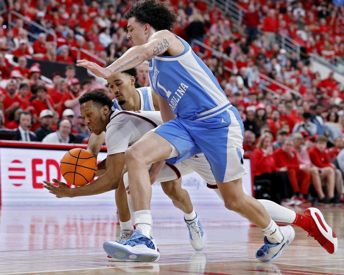 North Carolina’s Seth Trimble and Zayden High pressure N.C. State’s Quadir Copeland during the second half of the Wolfpack’s 82-58 win on Tuesday, Feb. 17, 2026, at Lenovo Center in Raleigh, N.C.