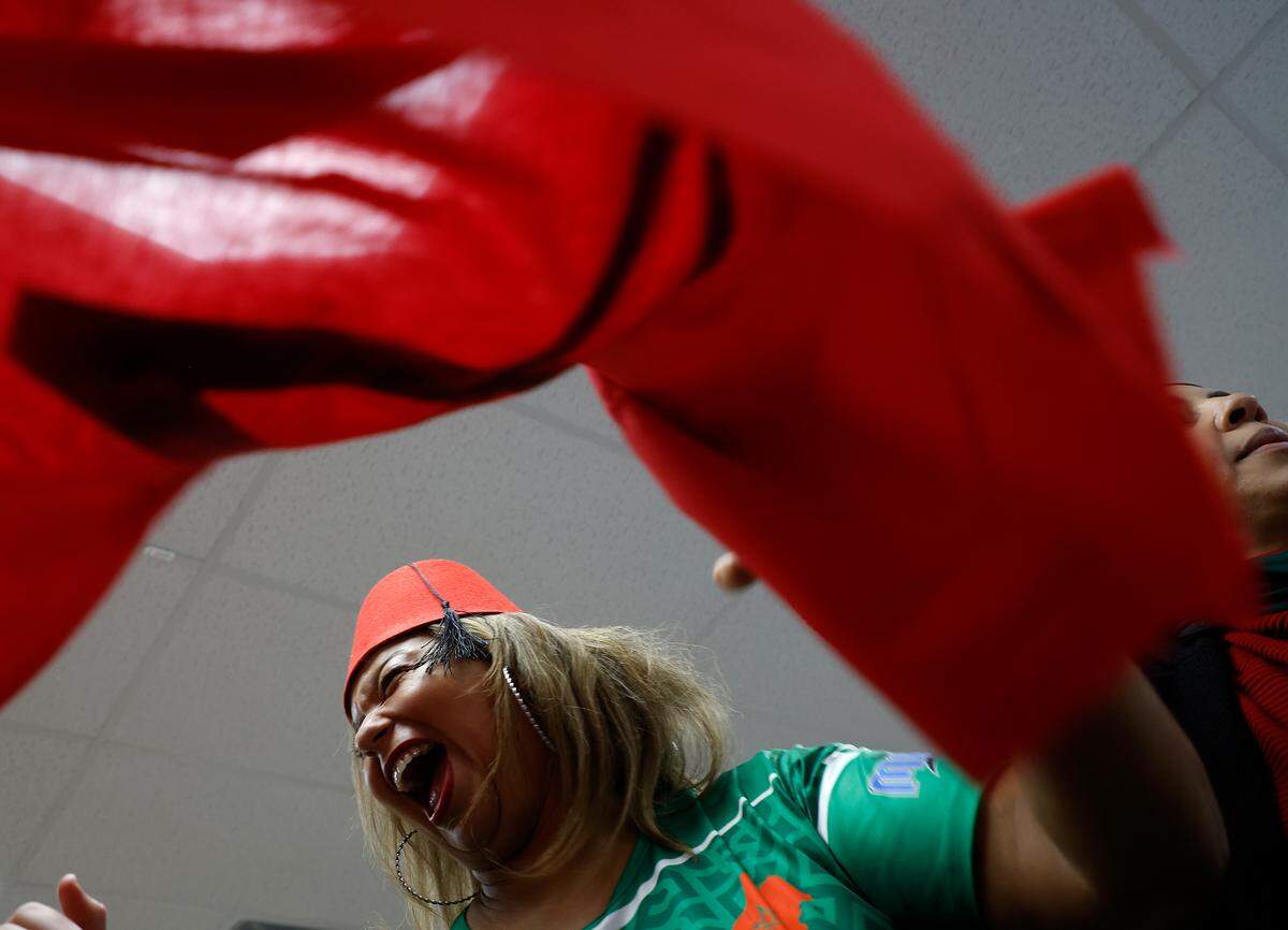 Wafaa Tullier smiles while dancing during halftime of the World Cup semifinal match between Morocco and France at La Recette patisserie in Durham, N.C. on Wednesday, Dec. 14, 2022.