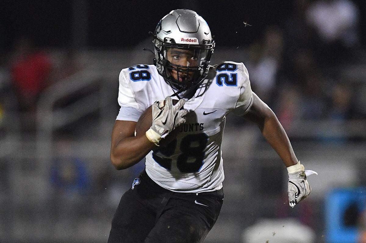 Panther Creek running back Travis Woodard (28) runs for yardage late in the second half against Apex. The Apex Cougars and the Panther Creek Catamounts met in a conference football game in Apex, N.C. on September 20, 2024.