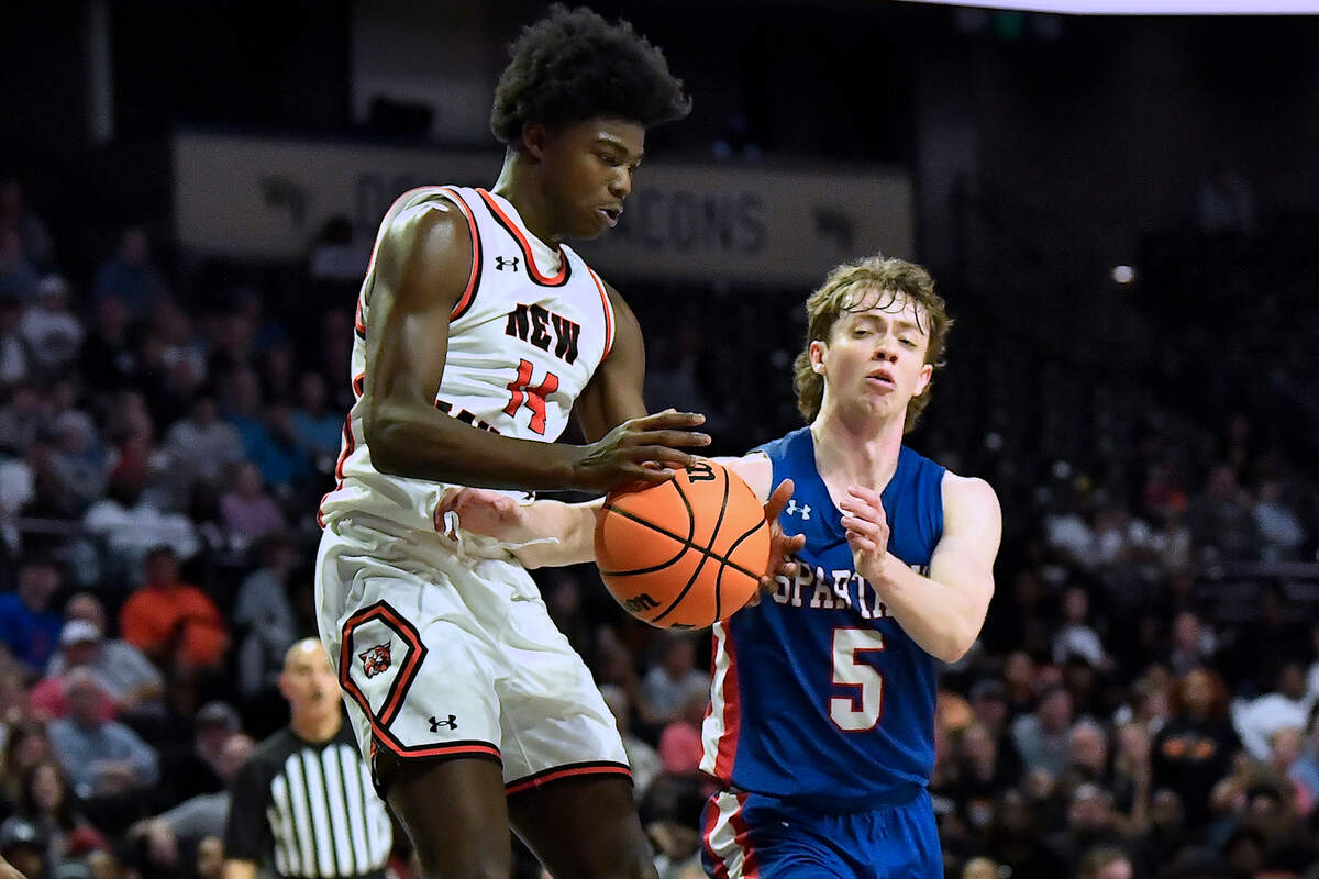 Sanderson’s Nathan Fife (5) competes with New Hanover’s Jazir Wright-McGhee (14) during the second half. The Sanderson Spartans and the New Hanover Wildcats met in the NCHSAA 4A East Regional Final in Winston-Salem, N.C. on March 12, 2025.