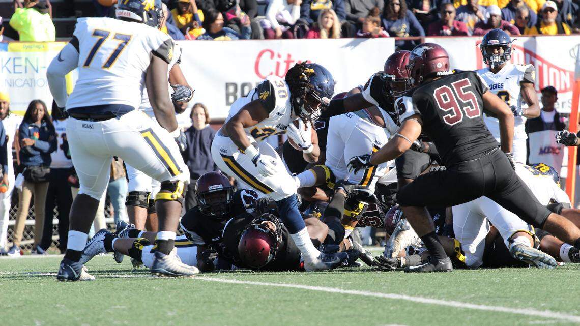 North Carolina A&T running back Jah-Maine Martin picks his way through the NCCU defense during the first half of the Aggie-Eagle Classic in Durham.