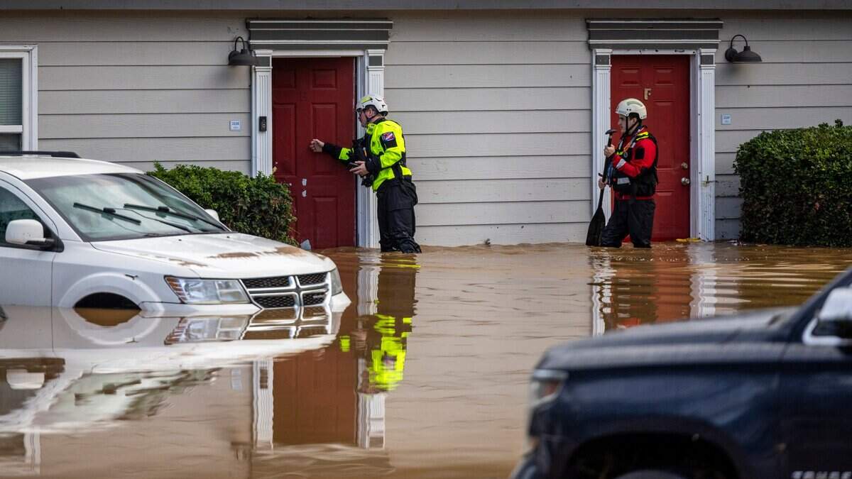 A water rescue unit with the Durham Fire Department knocks on doors at Rippling Streams Townhomes in the Old Farm neighborhood along the Eno River in Durham on Monday morning, July 7, 2025, after flash flooding caused by Tropical Storm Chantal.
