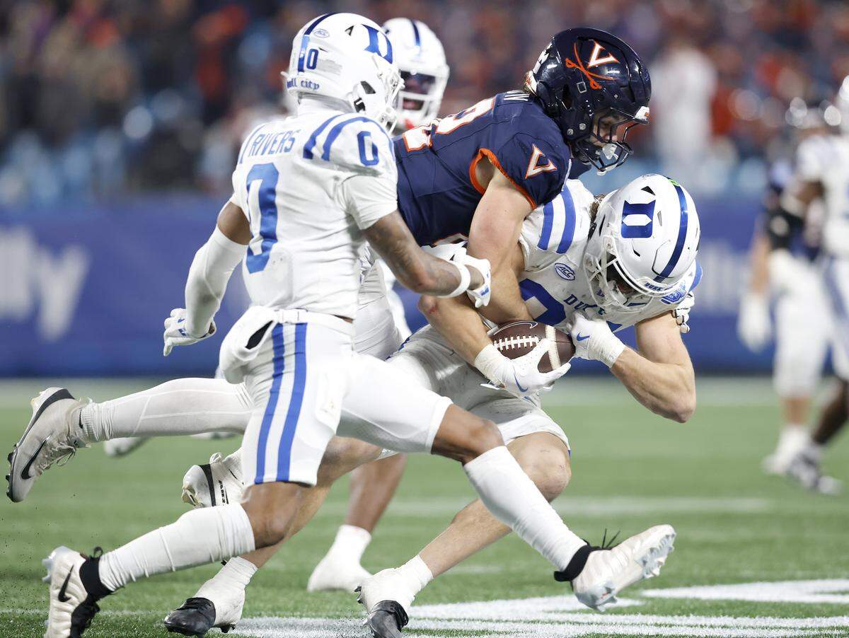 Duke’s Luke Mergott (34) intercepts a pass to clinch a 27-20 overtime victory for the Blue Devils over Virginia in the ACC Football Championship on Saturday, Dec. 6, 2025, at Bank of America Stadium in Charlotte, N.C.