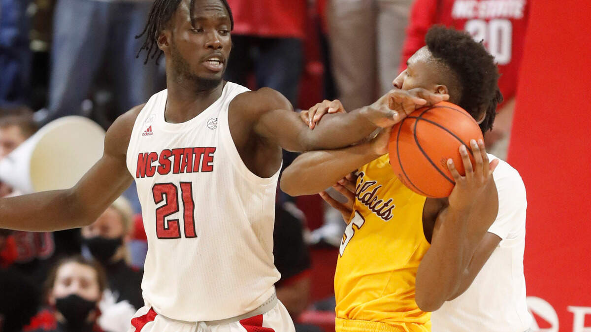 N.C. State’s Ebenezer Dowuona (21) pressures Bethune-Cookman’s Damani McEntire (5) during the second half of N.C. State’s 65-48 victory over Bethune-Cookman University at Reynolds Coliseum in Raleigh, N.C., Thursday, December 9, 2021.