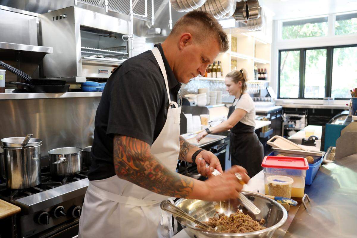 Chef Scott Crawford and chef de cuisine Madison Tessener works in the kitchen at Jolie in Raleigh on Aug. 22, 2019.