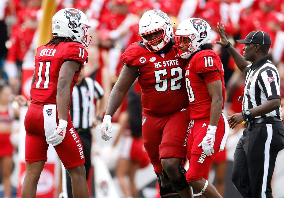 N.C. State’s Juice Vereen (11) and offensive lineman Timothy McKay (52) talk with KC Concepcion (10) after a pass intended for him was intercepted during the second half of Notre Dame’s 45-24 victory over N.C. State at Carter-Finley Stadium in Raleigh, N.C., Saturday, Sept. 9, 2023.