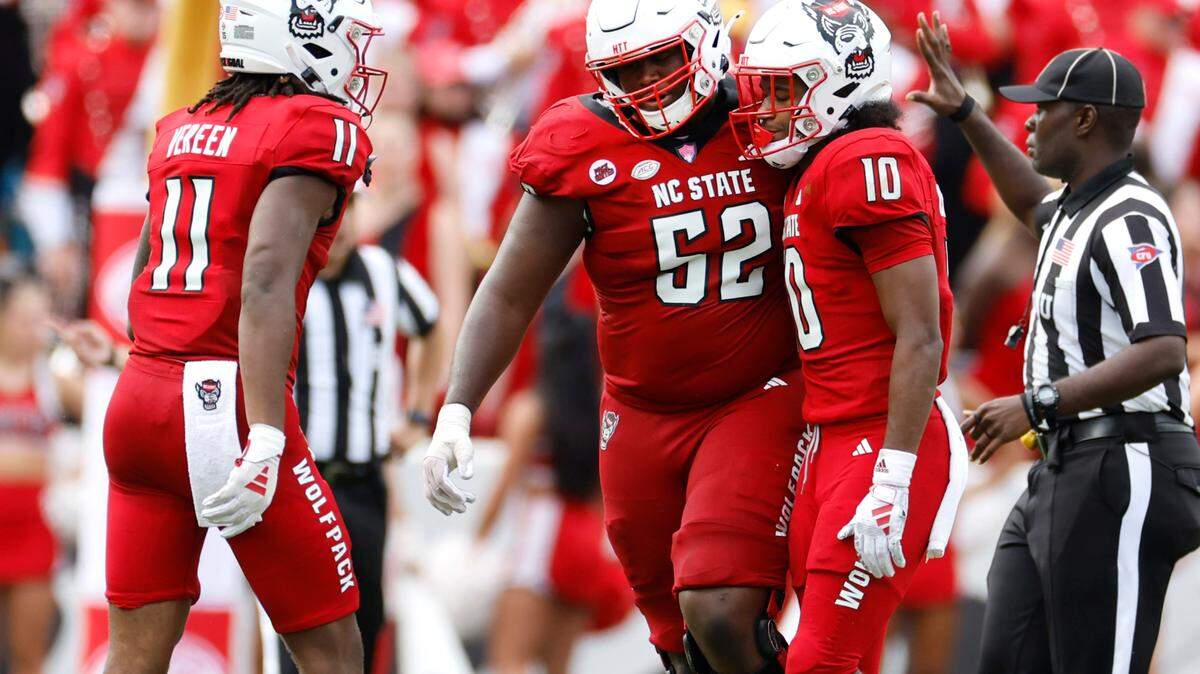 N.C. State’s Juice Vereen (11) and offensive lineman Timothy McKay (52) talk with KC Concepcion (10) after a pass intended for him was intercepted during the second half of Notre Dame’s 45-24 victory over N.C. State at Carter-Finley Stadium in Raleigh, N.C., Saturday, Sept. 9, 2023.