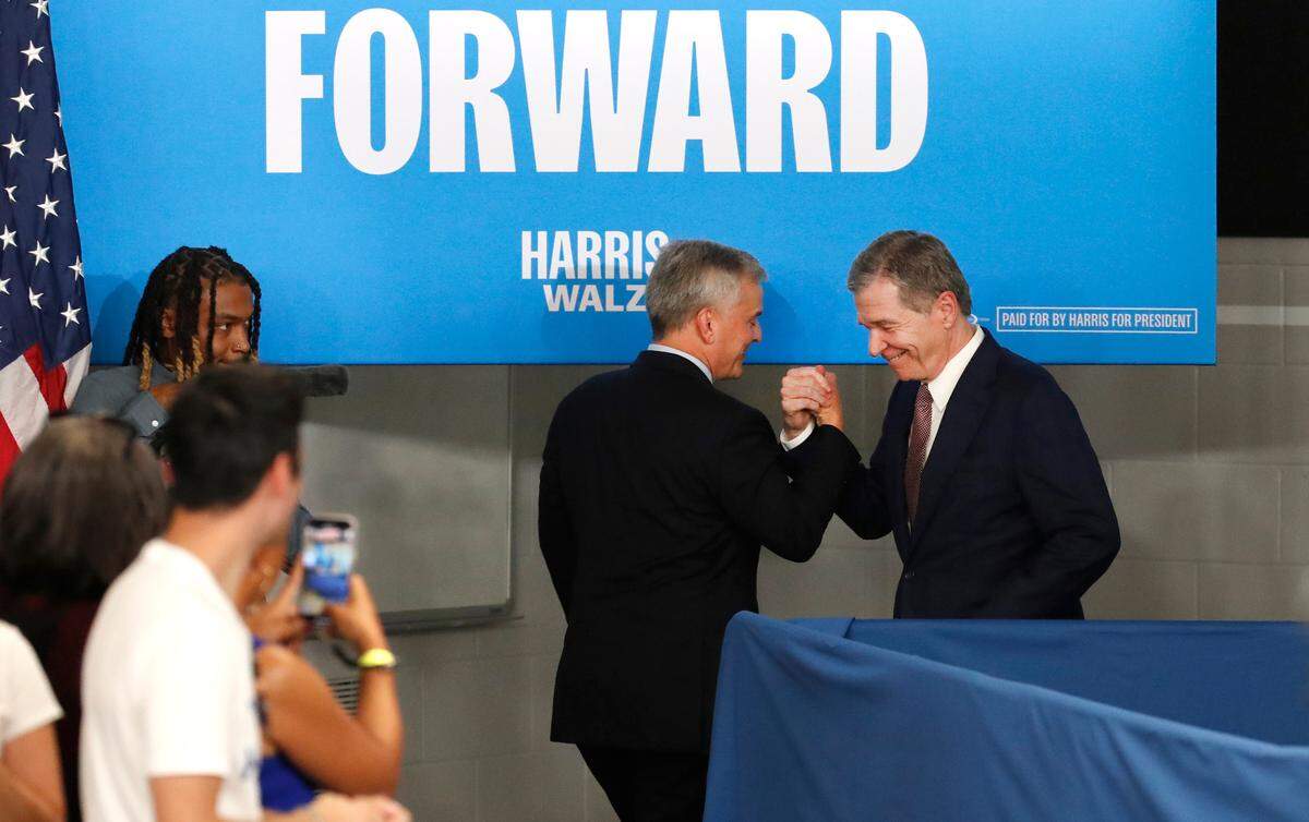 Gov. Roy Cooper greets Attorney General Josh Stein, who is running for governor, after Stein spoke during an event for Vice President and Democratic nominee for president Kamala Harris in Raleigh, N.C., Friday, August 16, 2024.