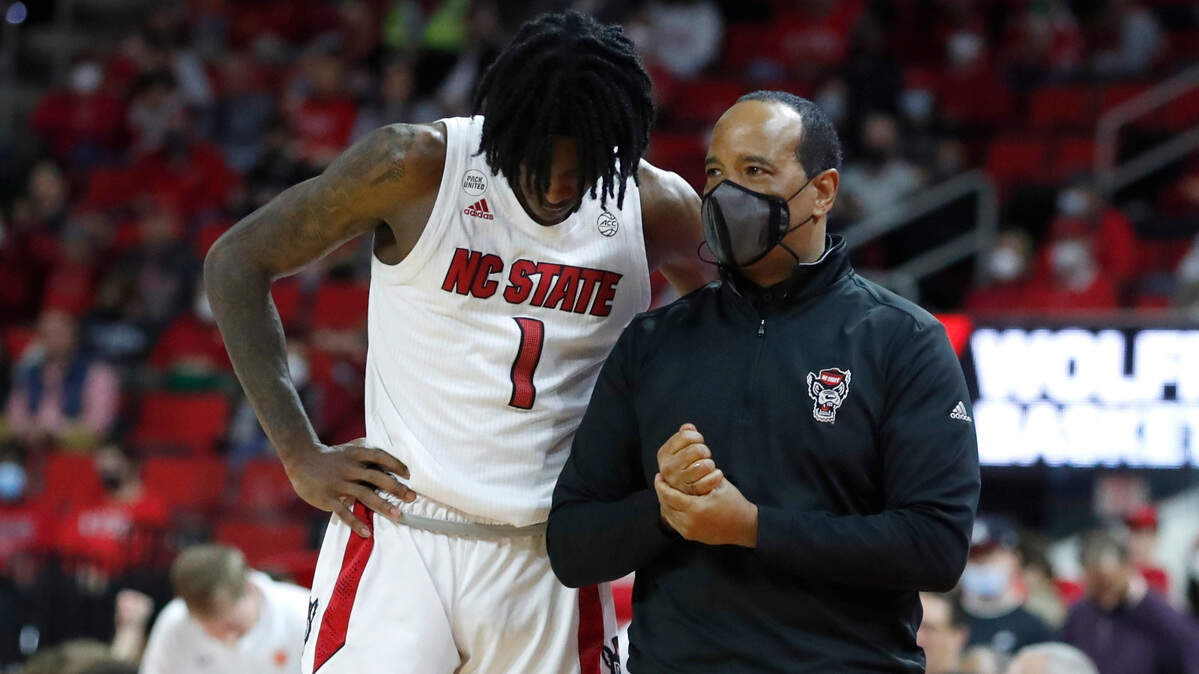 N.C. State head coach Kevin Keatts talks with Dereon Seabron (1) during the second half of Clemson’s 70-65 victory over N.C. State at PNC Arena in Raleigh, N.C., Saturday, January 8, 2022.