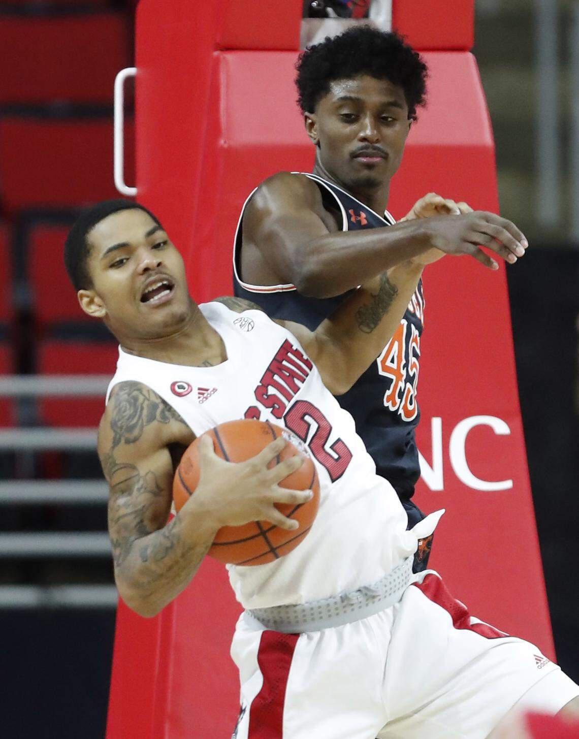 N.C. State’s Shakeel Moore (2) pulls in a rebound from Campbell’s Cedric Henderson Jr. (45) during the second half of N.C. State’s 69-50 victory over Campbell at PNC Arena in Raleigh, N.C., Saturday, Dec. 19, 2020.