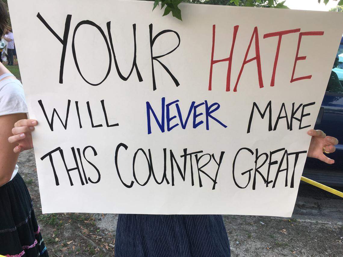 Kate Taylor holds a sign at a protest outside President Donald Trump’s rally at East Carolina University in Greenville, NC, on July 17, 2019.
