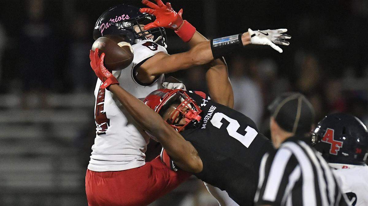 Middle Creek wide receiver Braylon Stewart (2) makes the pass reception against Apex Friendship’s Trevor Galvanek (4) during the second half. The Middle Creek Mustangs and the Apex Friendship Patriots met in a football game in Cary, N.C. on October 25, 2024.