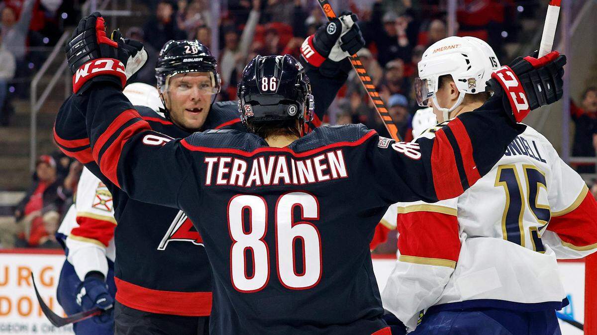Carolina Hurricanes’ Teuvo Teravainen (86) celebrates after his goal with teammate Paul Stastny (26) as Florida Panthers’ Anton Lundell (15) stands nearby during the second period of an NHL hockey game in Raleigh, N.C., Friday, Dec. 30, 2022. (AP Photo/Karl B DeBlaker)