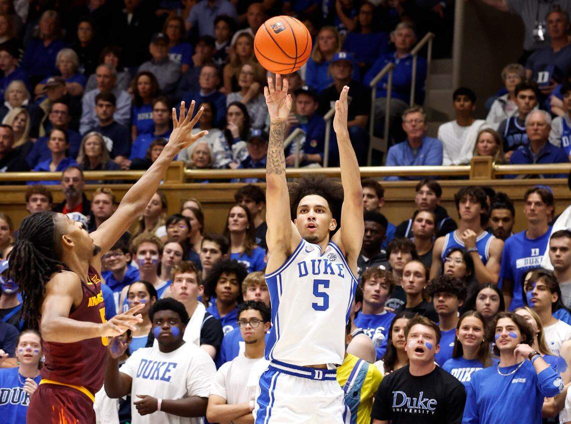Duke’s Tyrese Proctor (5) shoots a three-pointer as Arizona State’s Amier Ali (5) guards him during the first half of Duke’s game against Arizona State in the Brotherhood Run Charity Game at Cameron Indoor Stadium in Durham, N.C., Sunday, Oct. 27, 2024.