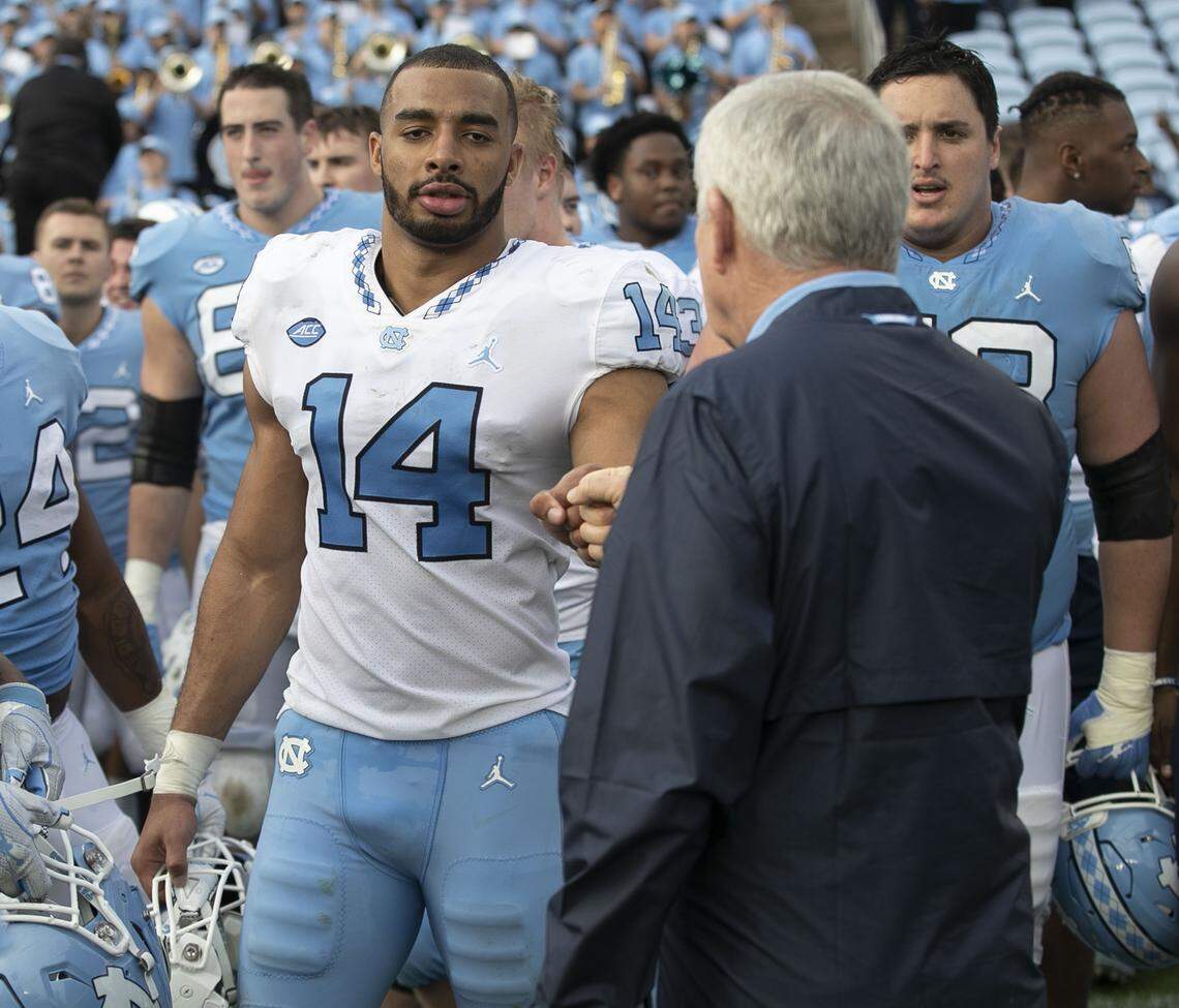North Carolina coach Mack Brown fist bumps Jake Lawler (14) following the Tar Heels’ Spring football game on Saturday, April 13, 2019 at Kenan Stadium in Chapel Hill, N.C.
