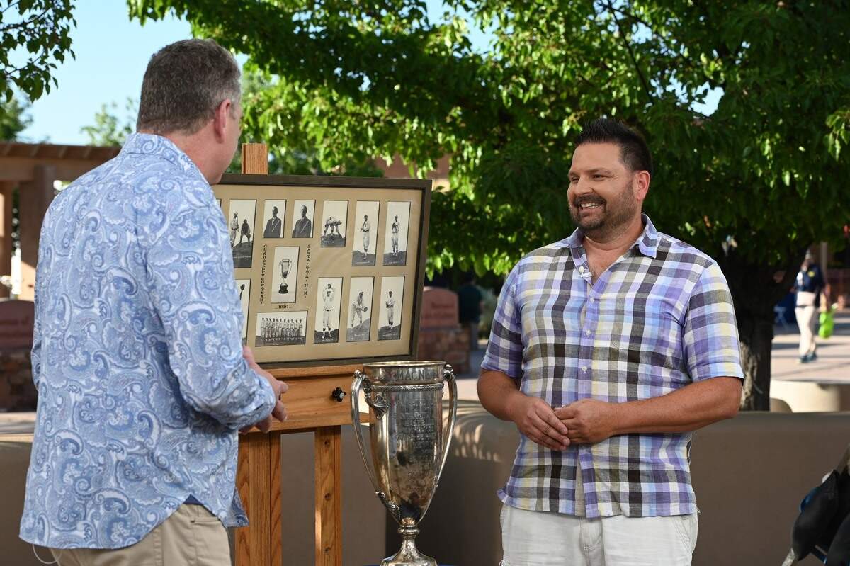 A man from Raleigh, NC, shows off his New Mexico Mining League baseball photos and trophy on the “Antiques Roadshow” Tour Santa Fe’s Museum Hill in Santa Fe, New Mexico. The episode was filmed on June 14, 2022 and aired on January 23, 2023.