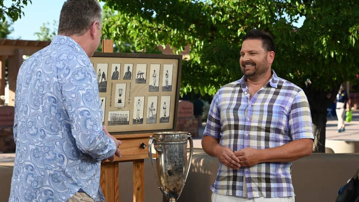 A man from Raleigh, NC, shows off his New Mexico Mining League baseball photos and trophy on the “Antiques Roadshow” Tour Santa Fe’s Museum Hill in Santa Fe, New Mexico. The episode was filmed on June 14, 2022 and aired on January 23, 2023.