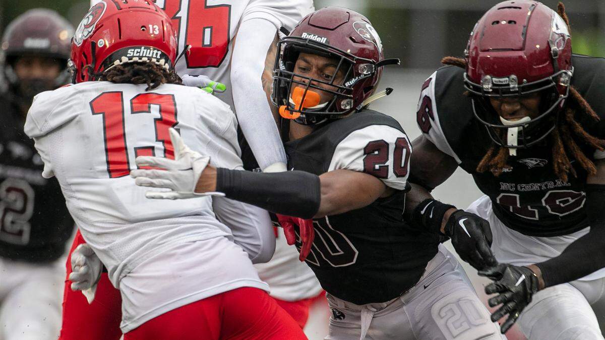 North Carolina Central’s Khalil Baker (20) stops Winston-Salem State’s Chad Turner (13) in the second quarter on Saturday, September 10, 2022 at O’Kelly-Riddick Stadium in Durham, N.C.