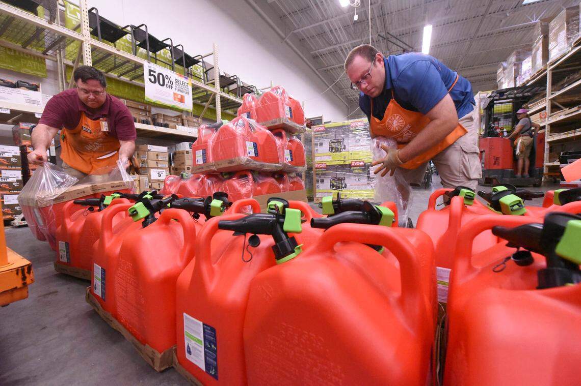 Mark Bratton and Chris Earley put out gas tanks at the Home Depot in Monkey Junction, N.C., Monday Sept. 2, 2019.